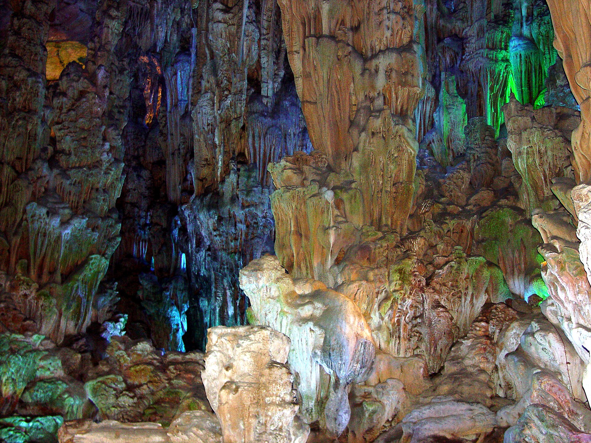 Stalactites and rock formations inside Guilin's Reed Flute Cave under multicoloured display lighting in 2006.
