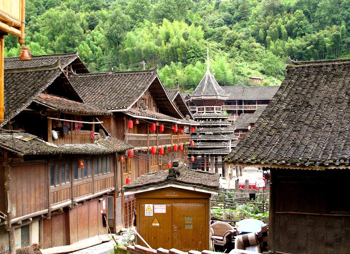 A drum tower rises between dense wooden roofs in Zhaoxing, Guizhou.