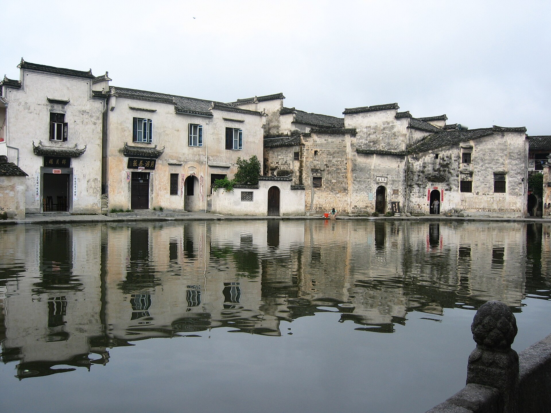 White-walled buildings reflect in Moon Pond at Hongcun in Anhui.