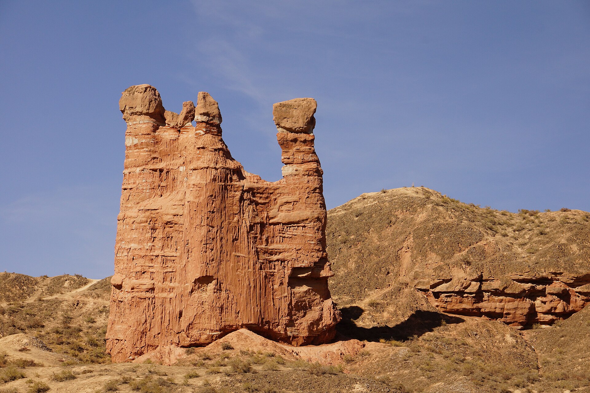 Tower-like red sandstone formations rise in the Binggou Danxia area near Zhangye.